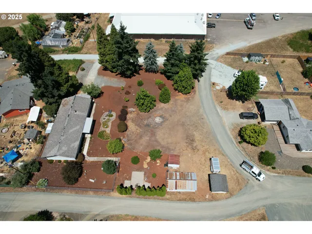 an aerial view of multiple houses with yard