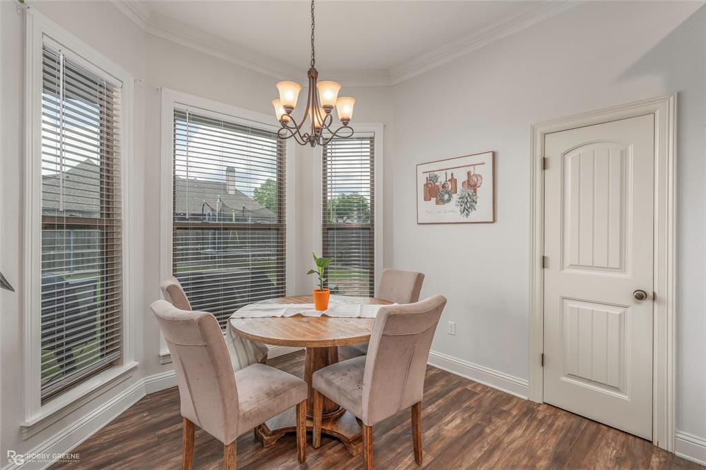 711 Reeds Reef Bossier City, LA 71112 - Photo 15 of 36 a view of a dining room with furniture window and wooden floor