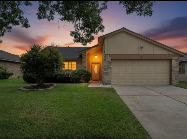 a view of house with backyard space and garden