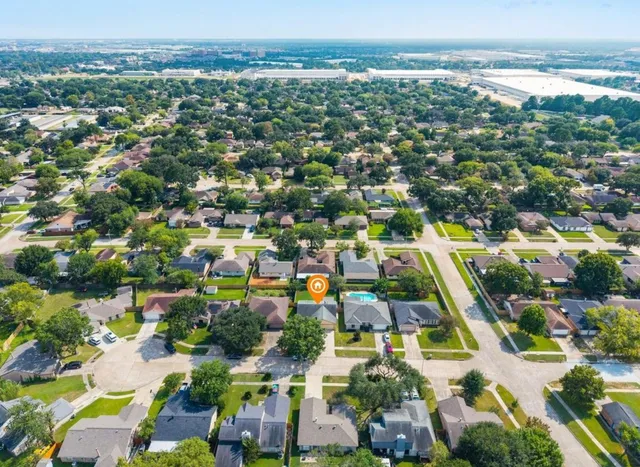 an aerial view of residential houses with outdoor space