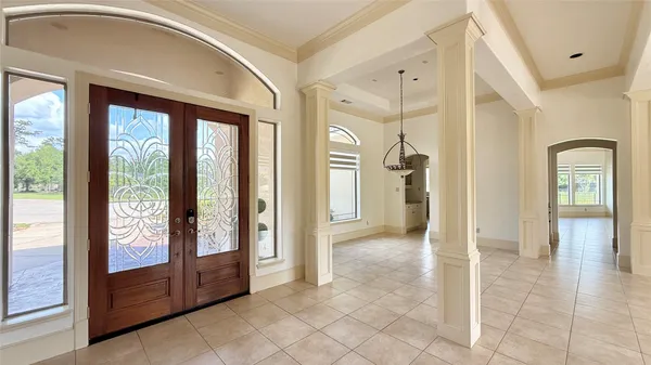 a view of a hallway with bathroom and shower