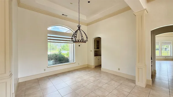 a view of an empty room with a fireplace and a large window