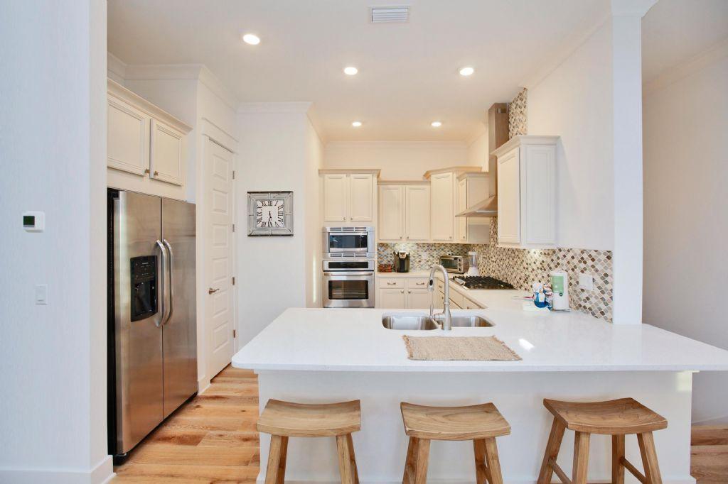 44 Pine Lands Loop Inlet Beach West, Unit C Inlet Beach, FL 32461 - Photo 5 of 27 a large kitchen with a table and chairs
