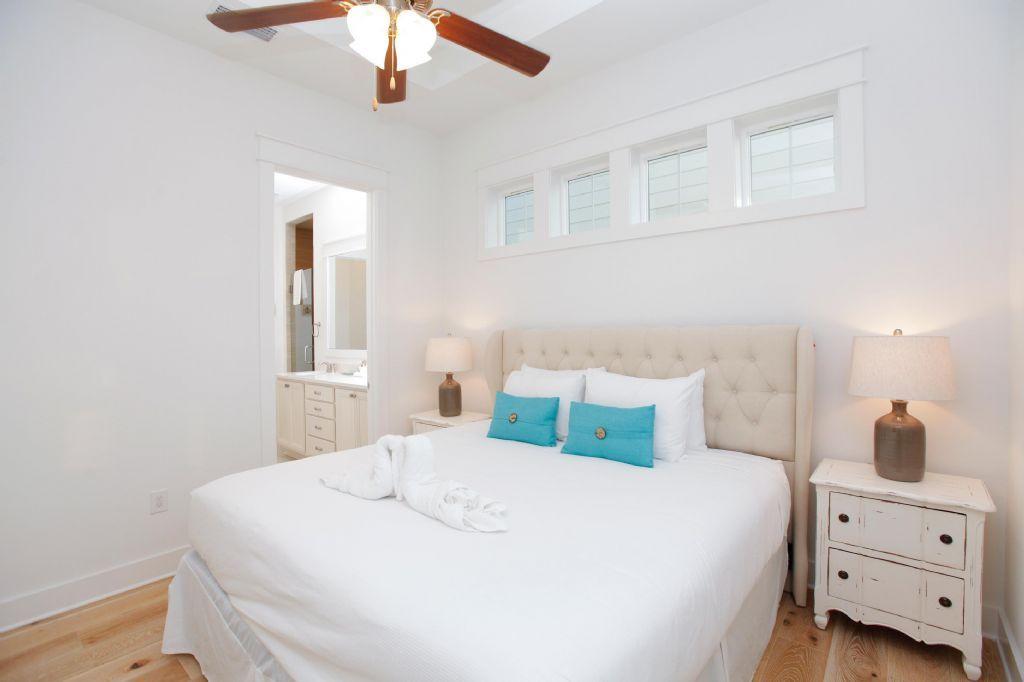 44 Pine Lands Loop Inlet Beach West, Unit C Inlet Beach, FL 32461 - Photo 6 of 27 a bedroom with a large bed and a chandelier