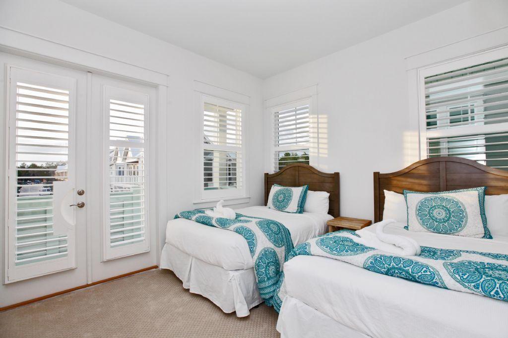 44 Pine Lands Loop Inlet Beach West, Unit C Inlet Beach, FL 32461 - Photo 8 of 27 a bedroom with two beds and a window