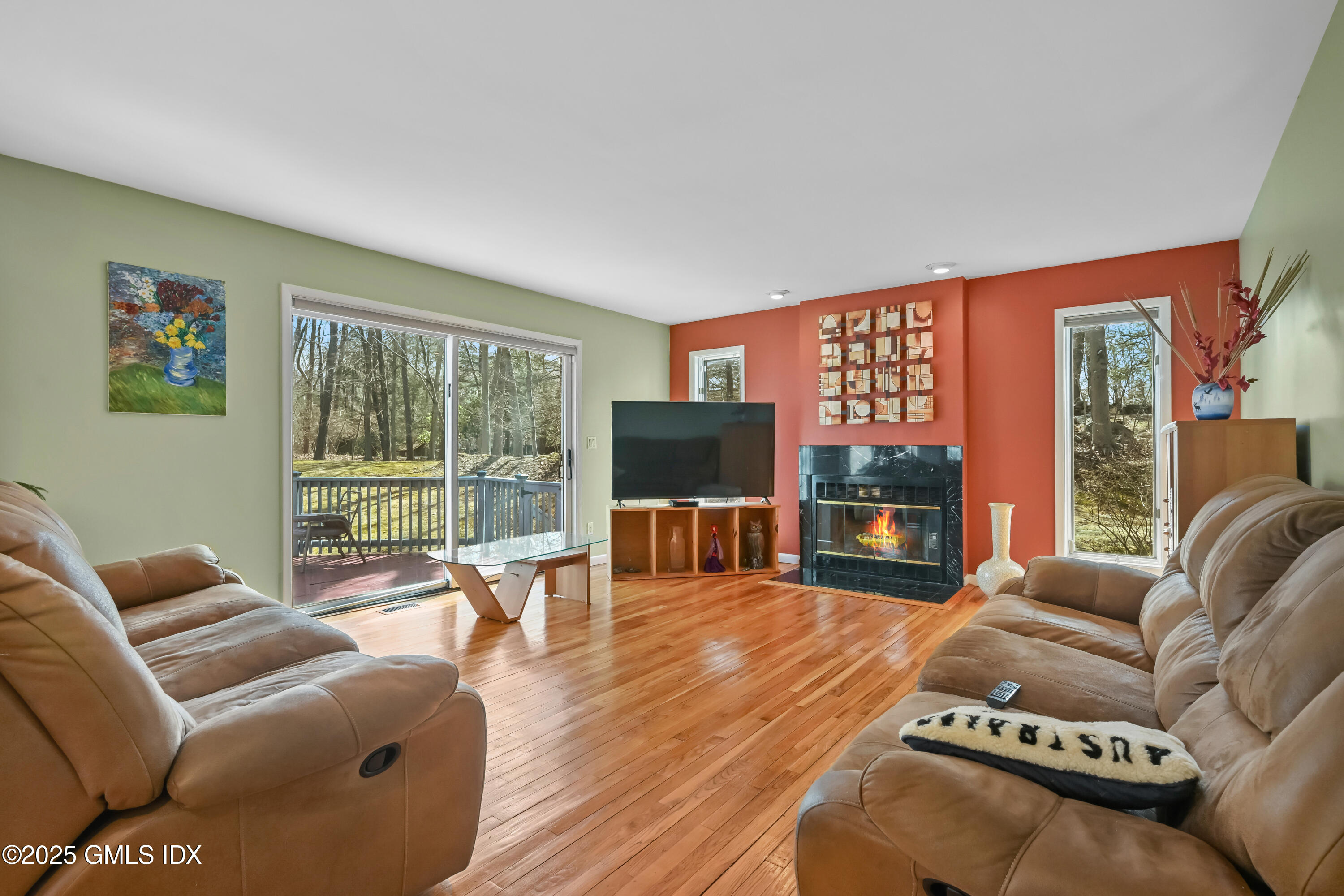 681 River Road Cos Cob, CT 06807 - Photo 11 of 44 a living room with furniture floor to ceiling window and a flat screen tv