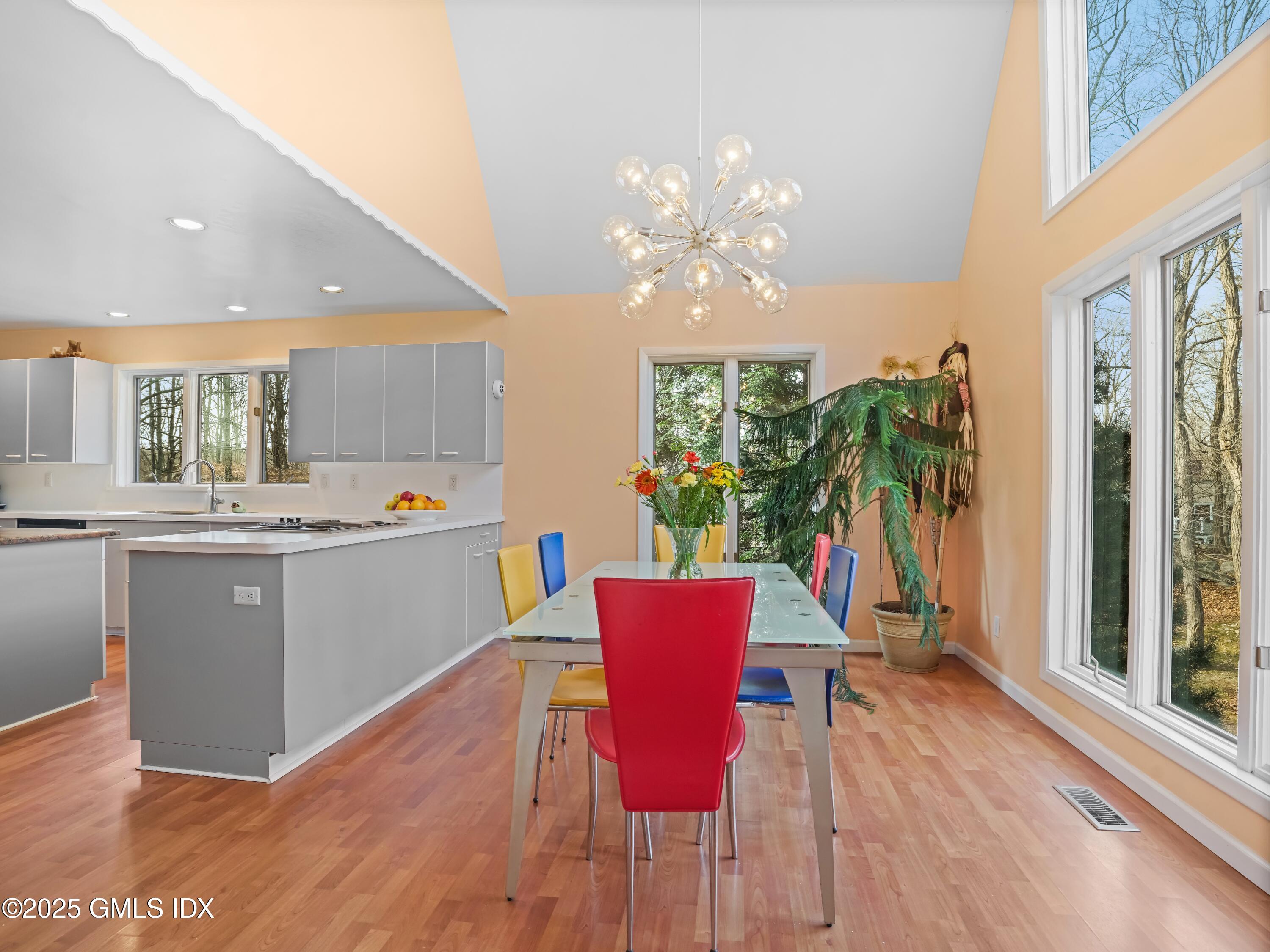 681 River Road Cos Cob, CT 06807 - Photo 19 of 44 a view of a dining room with furniture a chandelier and wooden floor