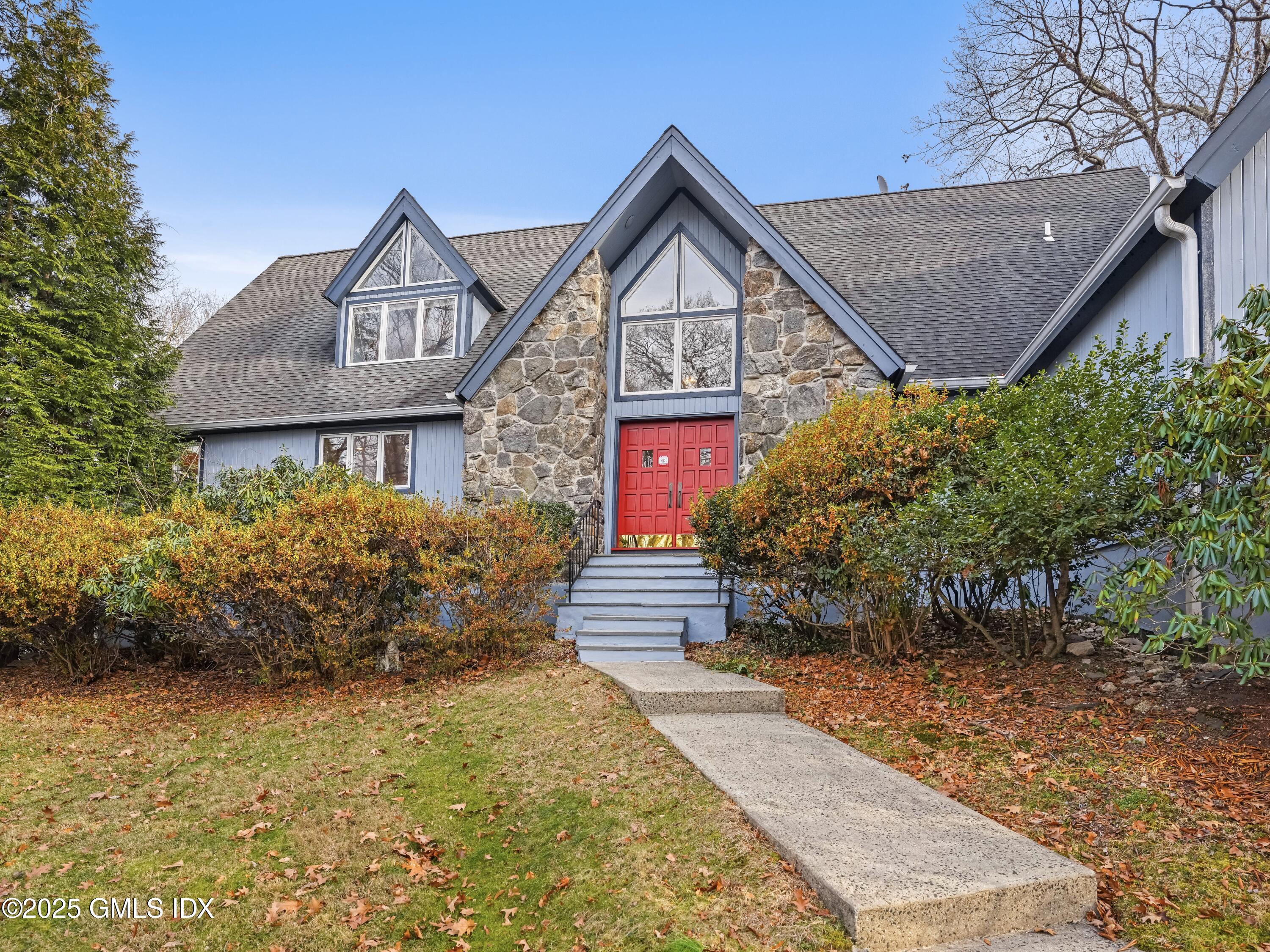 681 River Road Cos Cob, CT 06807 - Photo 2 of 44 a front view of a house with garden