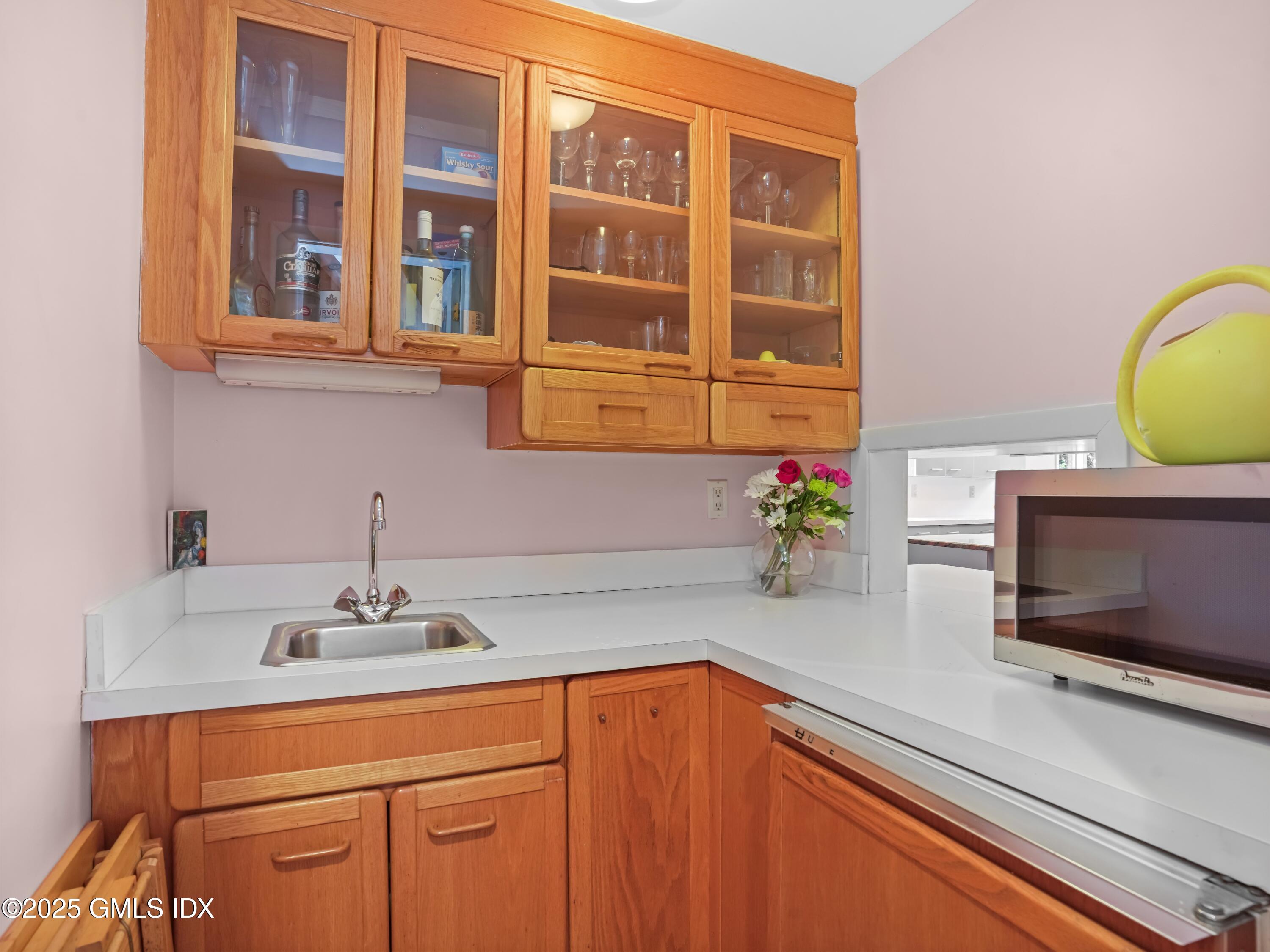 681 River Road Cos Cob, CT 06807 - Photo 21 of 44 a kitchen with stainless steel appliances a sink and cabinets