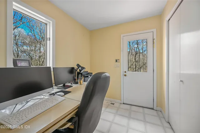 a bedroom with a bed and a large window with outer view