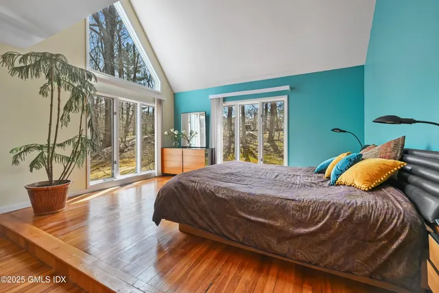 a bedroom with furniture and a wooden floor
