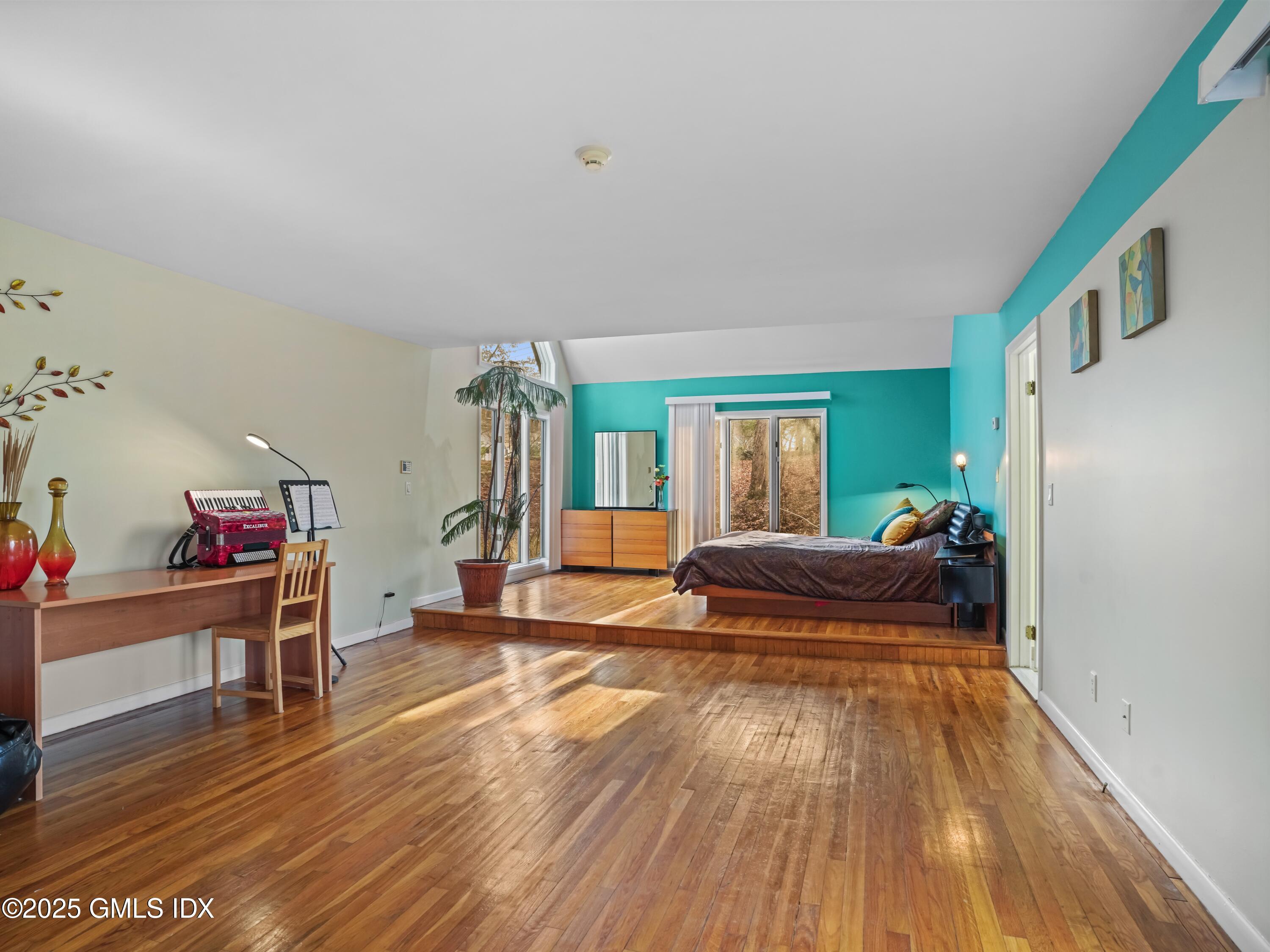 681 River Road Cos Cob, CT 06807 - Photo 24 of 44 a bedroom with furniture and a wooden floor