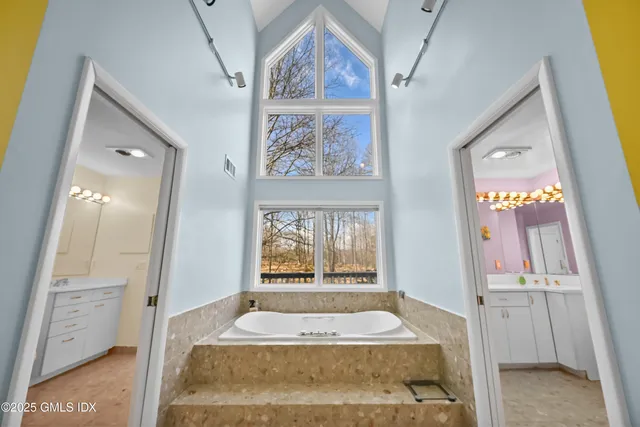 a spacious bathroom with a shower sink and mirror