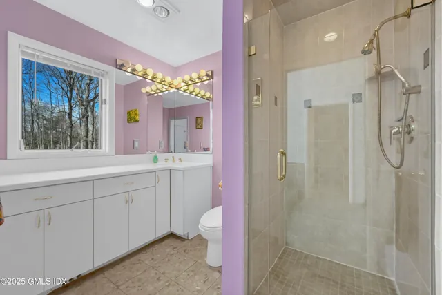 a bathroom with a shower sink and mirror