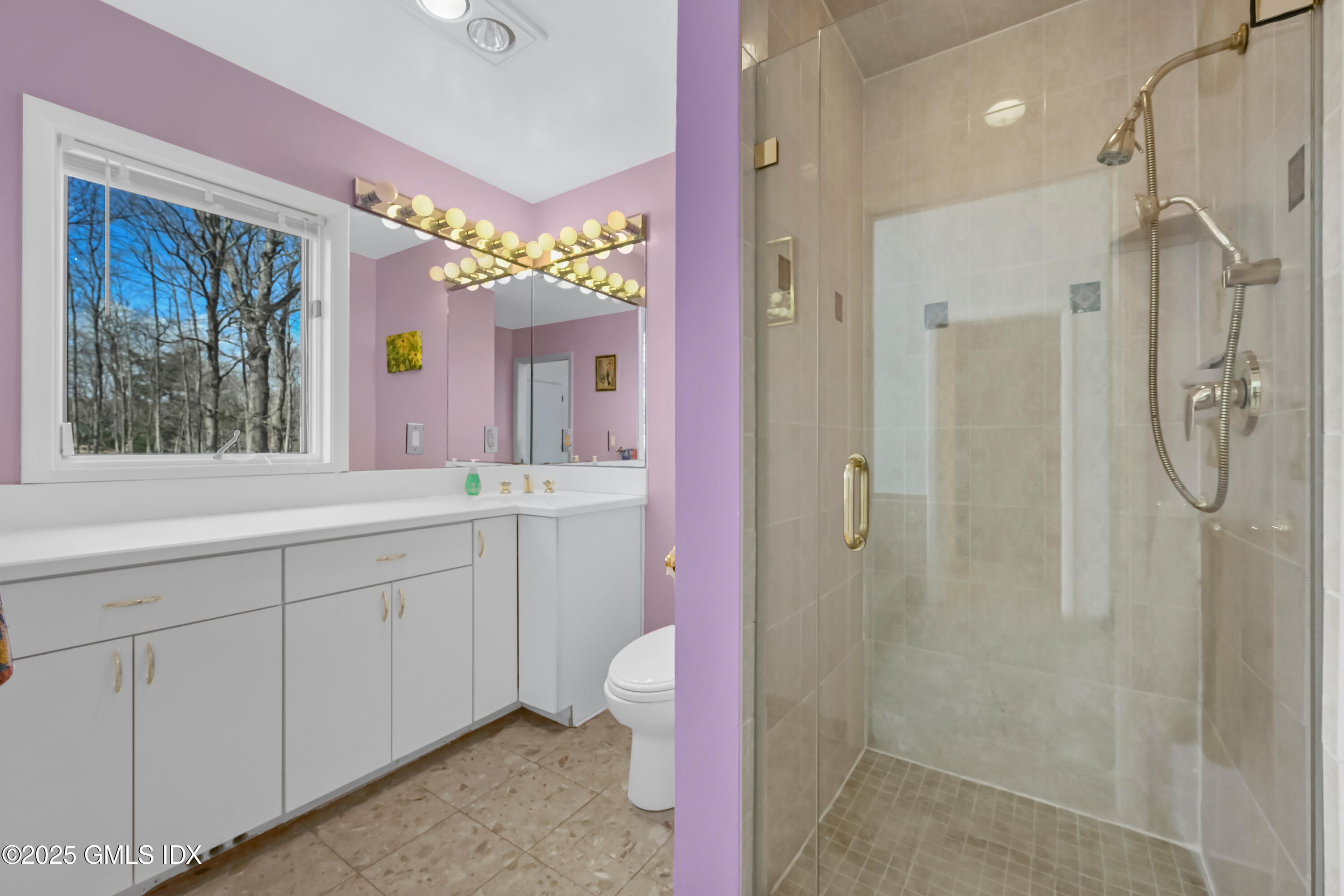 681 River Road Cos Cob, CT 06807 - Photo 26 of 44 a spacious bathroom with a shower sink and mirror