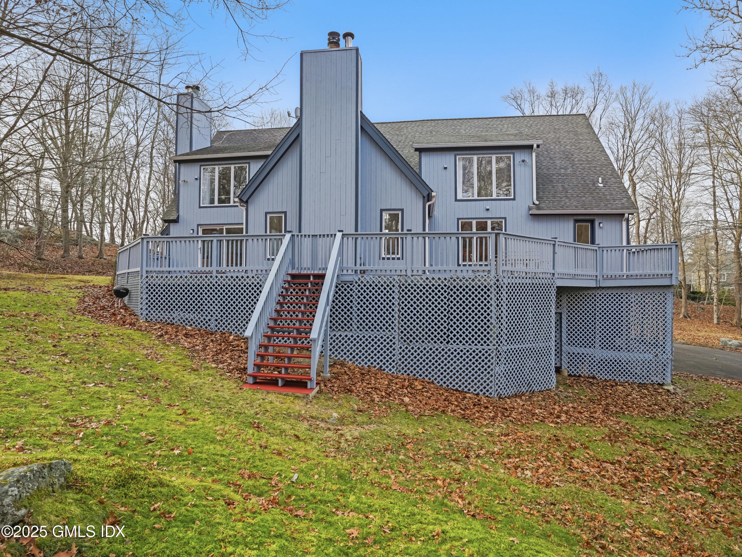 681 River Road Cos Cob, CT 06807 - Photo 40 of 44 a front view of a house with a yard