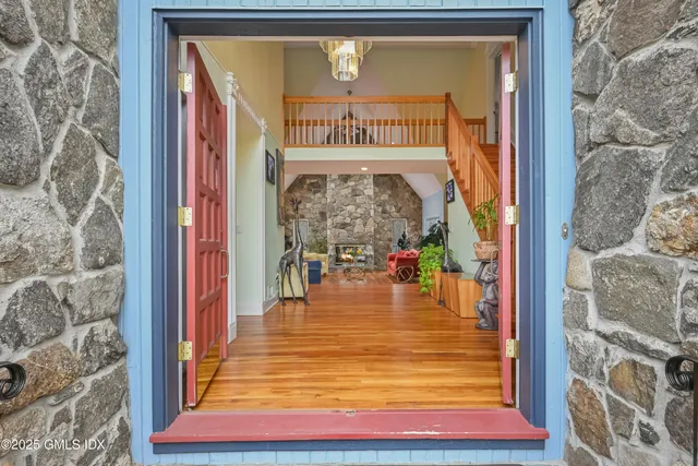 a view of an entryway with wooden floor