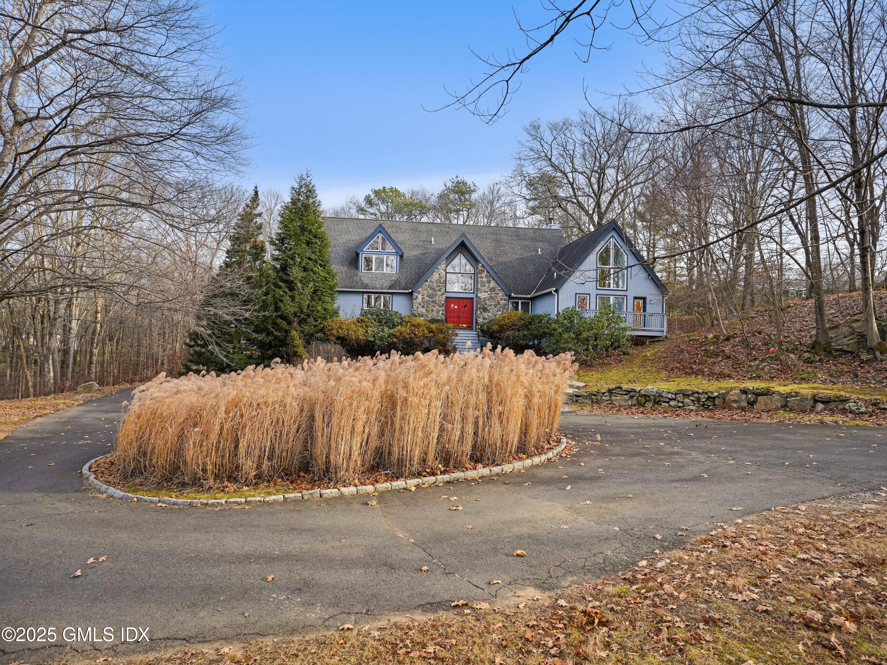 681 River Road Cos Cob, CT 06807 - Photo 42 of 44 a front view of a house with a yard and garage
