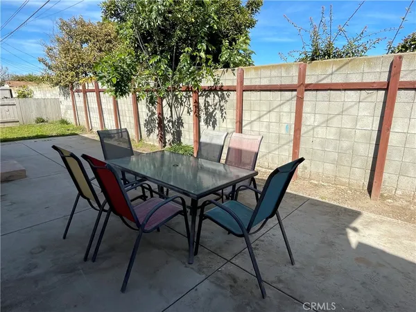 a view of a patio with a table and chairs