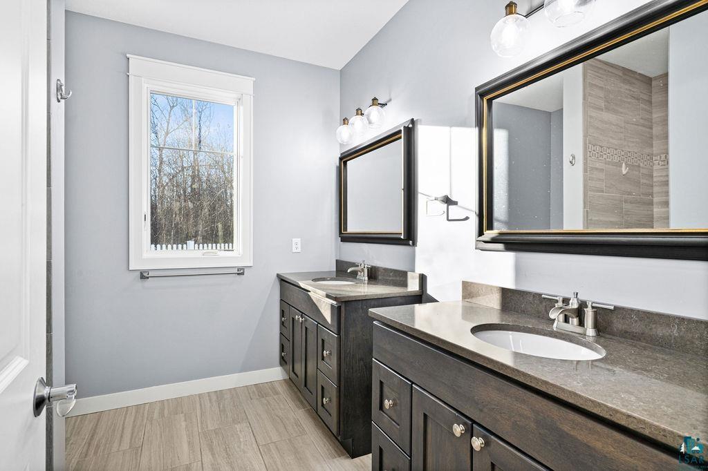 3879 Okerstrom Road Hermantown, MN 55811 - Photo 29 of 32 Full bathroom featuring two vanities and light wood finished floors