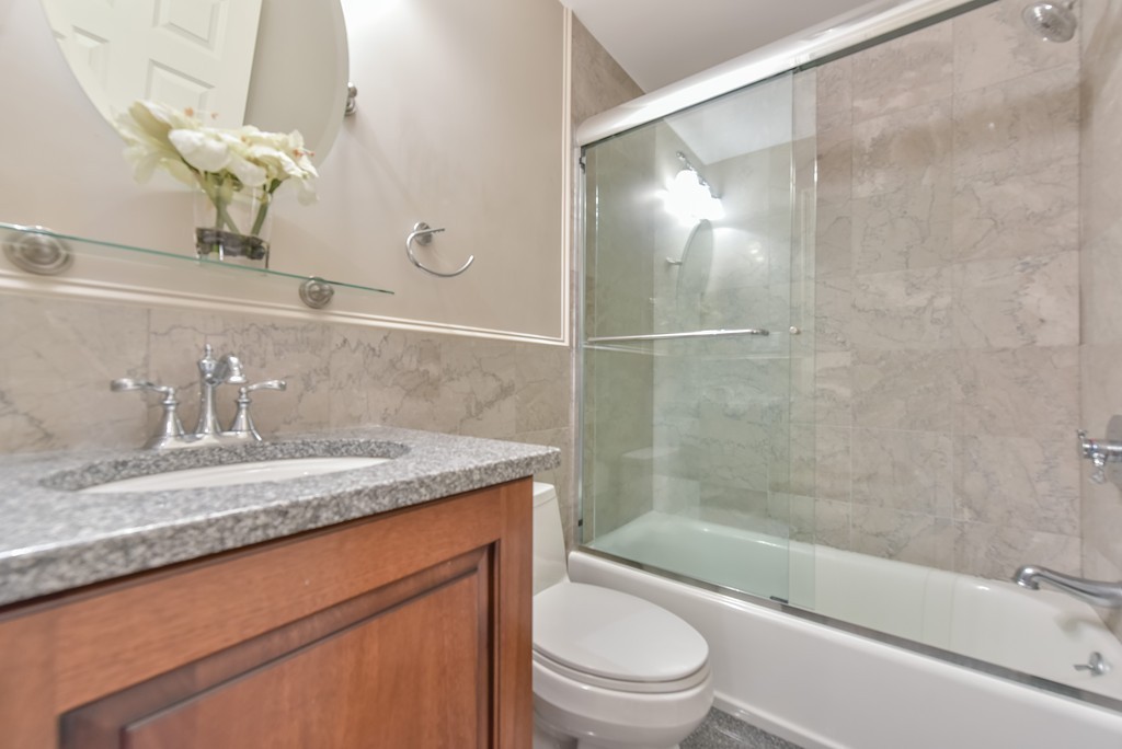 88 Wiswall Road Newton, MA 02459 - Photo 11 of 30 a bathroom with a granite countertop sink a toilet and bathtub