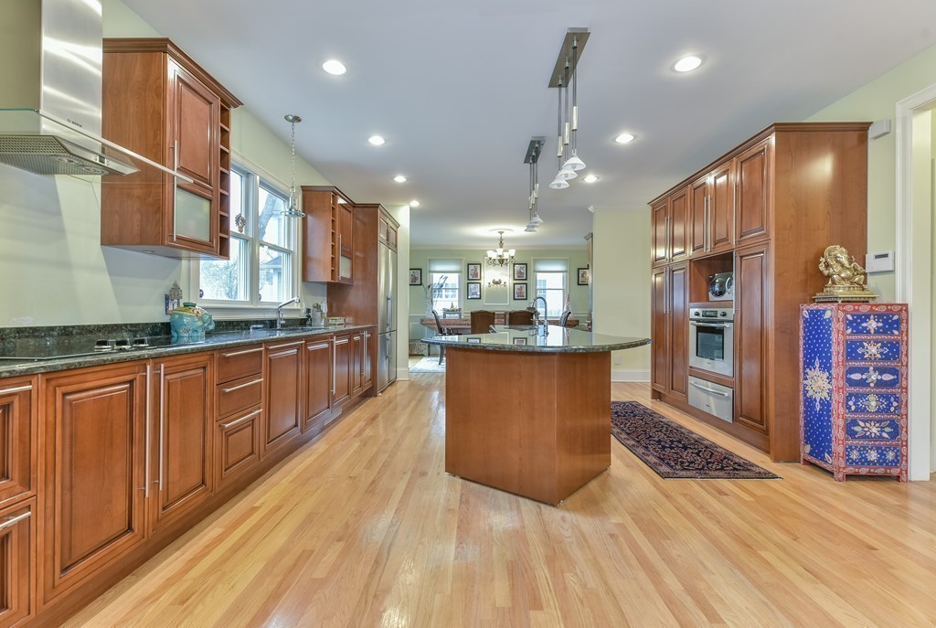 88 Wiswall Road Newton, MA 02459 - Photo 16 of 30 a large kitchen with stainless steel appliances kitchen island granite countertop a large counter top and wooden floors