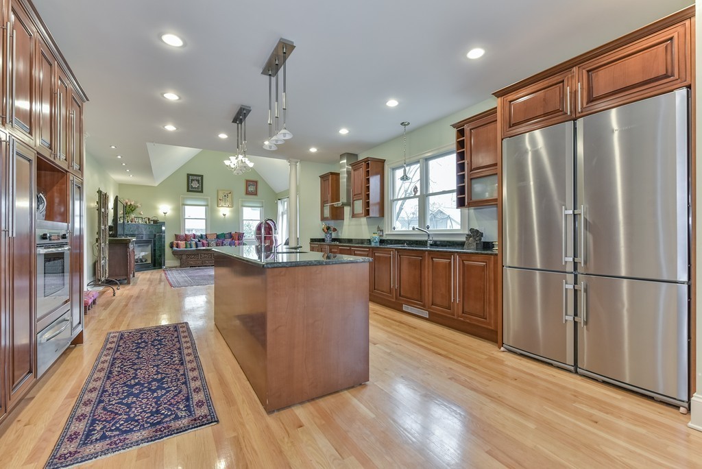 88 Wiswall Road Newton, MA 02459 - Photo 3 of 30 a kitchen with stainless steel appliances granite countertop a refrigerator a stove and a wooden floors