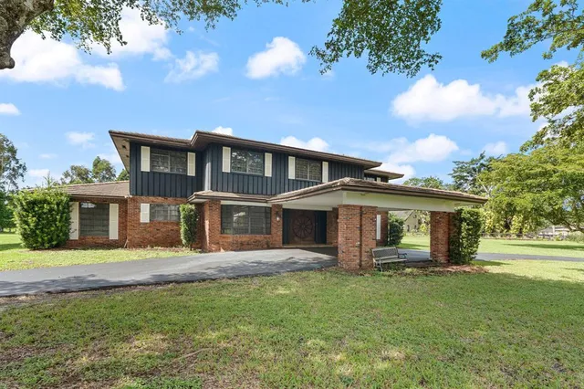 a front view of a house with a yard table and chairs