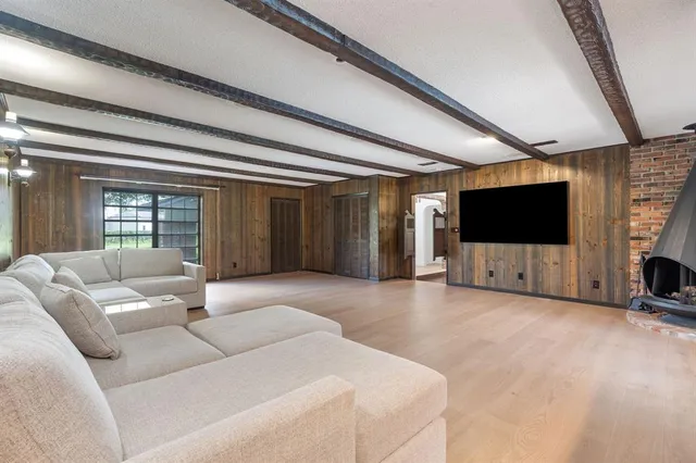 a view of a livingroom with furniture wooden floor and window