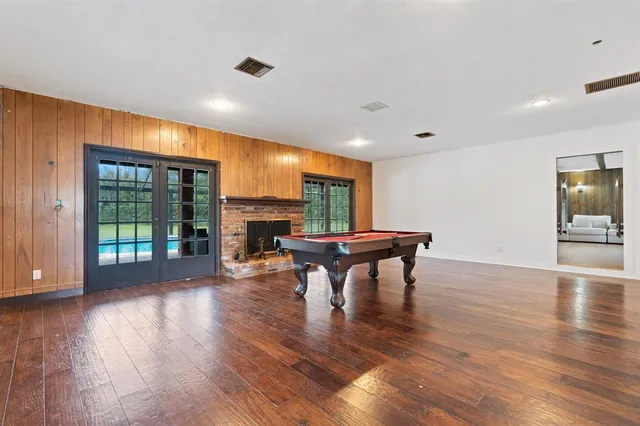 a view of a room with wooden floor furniture and windows