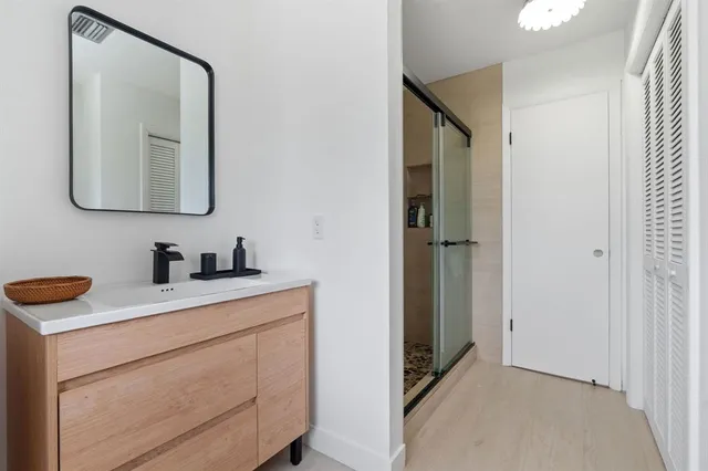a bed sitting in a spacious bedroom next to a window