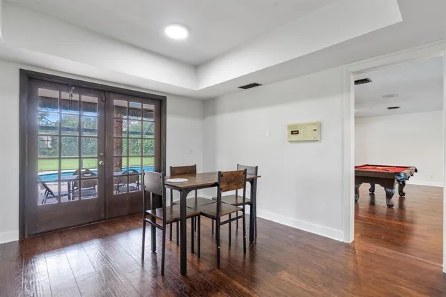 a kitchen with stainless steel appliances granite countertop a kitchen island a stove a table and chairs