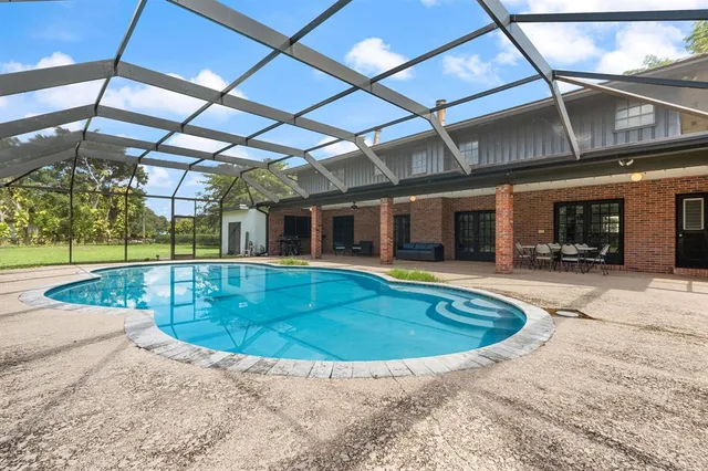 a view of a swimming pool with a yard