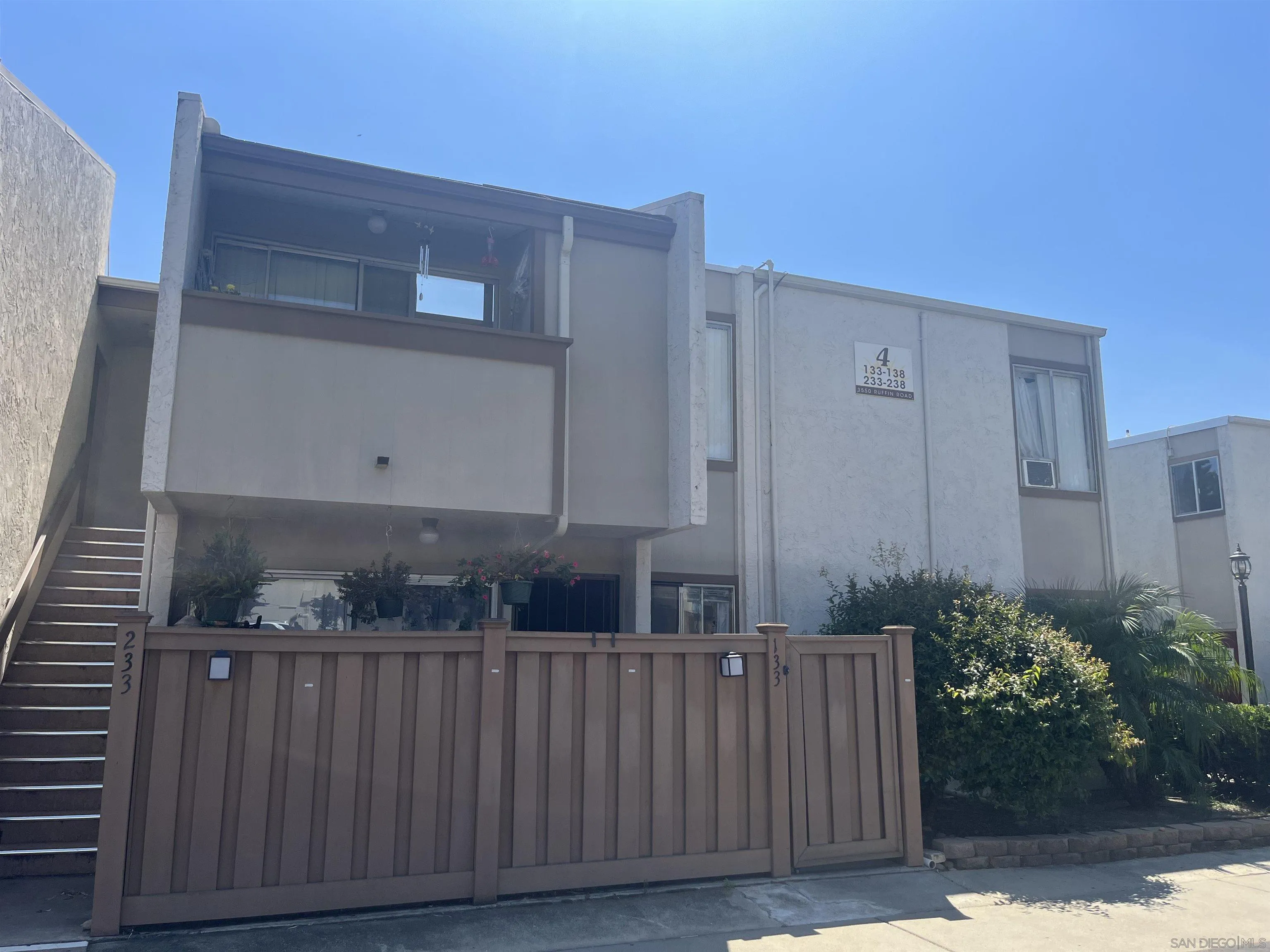 a view of a house with a wooden fence