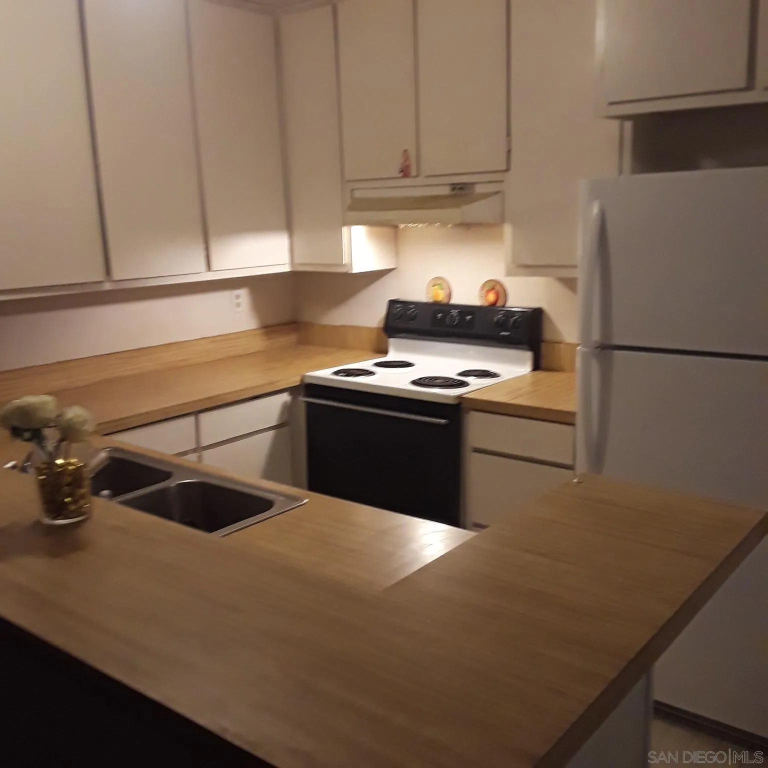 3550 Ruffin Road, Unit 233 San Diego, CA 92123 - Photo 9 of 17 a kitchen with a sink and a refrigerator