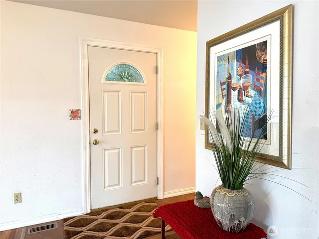 a kitchen with stainless steel appliances granite countertop a stove top oven a sink a counter space and a window