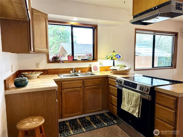 a kitchen with a stove a sink and a microwave