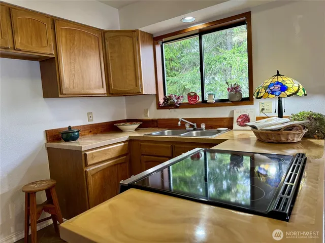 a room with lots of flower plants and wooden floor