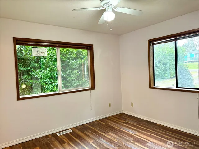 a bathroom with a sink a mirror and a potted plant