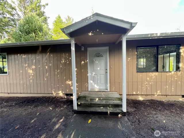 a front view of a house with a garden