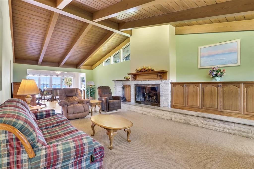 719 Southeast Riverside Drive Stuart, FL 34994 - Photo 3 of 17 a living room with patio furniture and a fireplace
