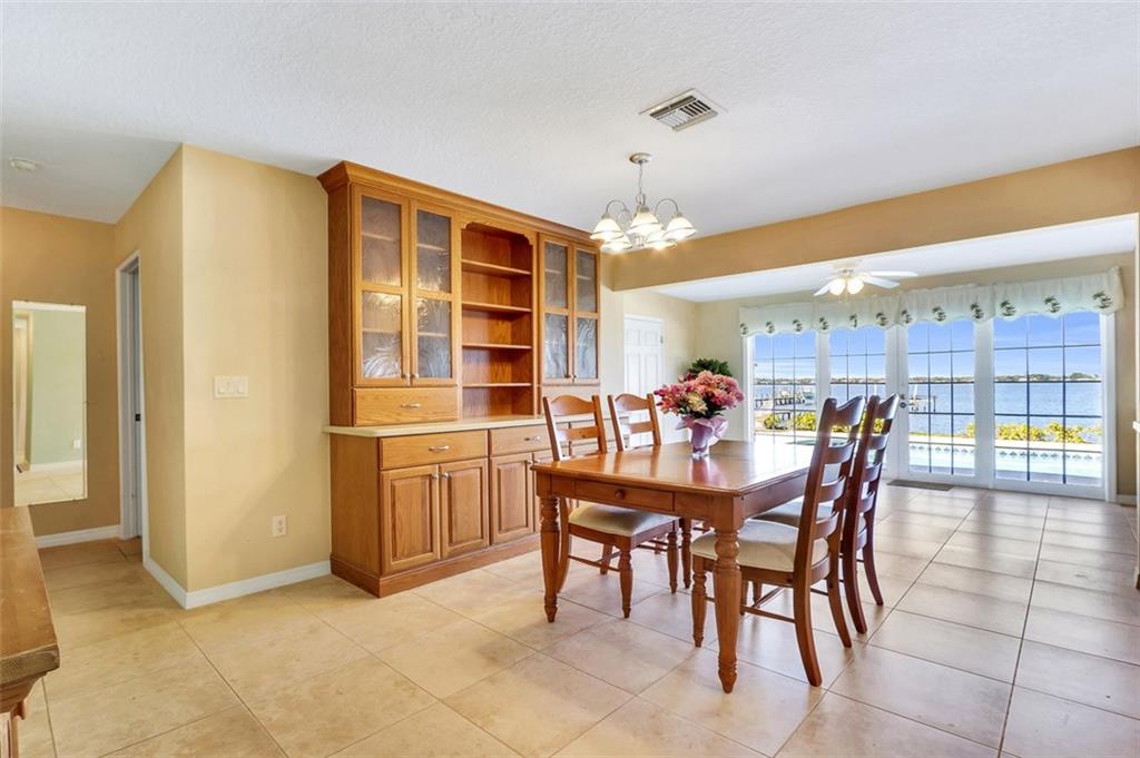 719 Southeast Riverside Drive Stuart, FL 34994 - Photo 4 of 17 a dining area with stainless steel appliances a table and chairs