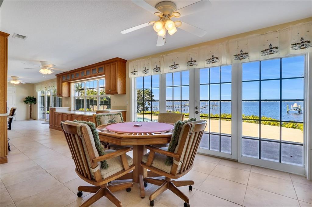 719 Southeast Riverside Drive Stuart, FL 34994 - Photo 7 of 17 a dining room with furniture and a floor to ceiling window
