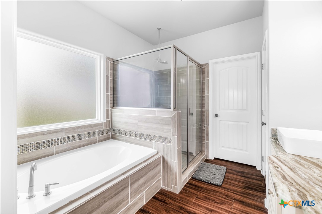 204 James Street Inez, TX 77968 - Photo 17 of 35 a bathroom with a bathtub and a shower