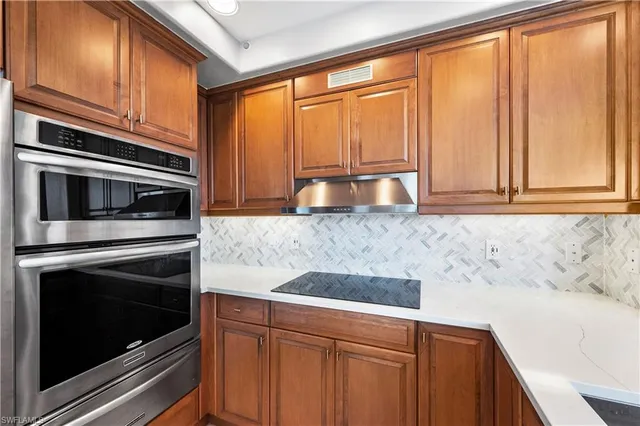 a kitchen with granite countertop cabinets stainless steel appliances and a sink