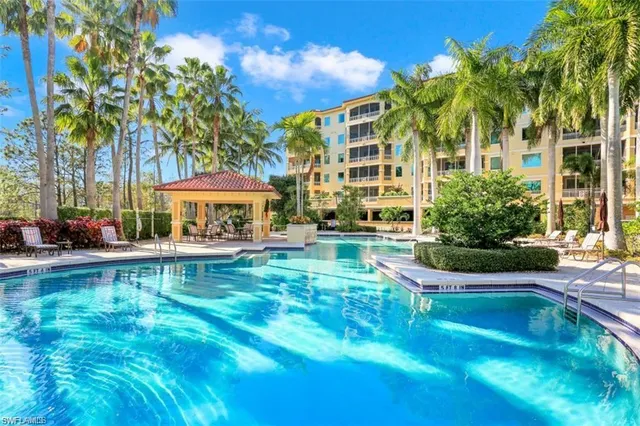a front view of a house with swimming pool having outdoor seating