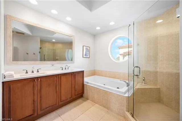 a bedroom with a bed and a dresser with wooden floor