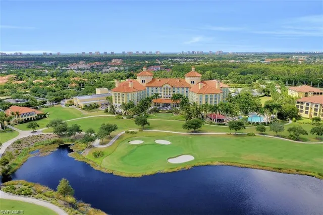 an aerial view of a house with a swimming pool big yard and mountain view in back