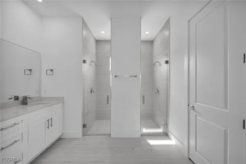 a bathroom with a granite countertop sink a shower and a mirror