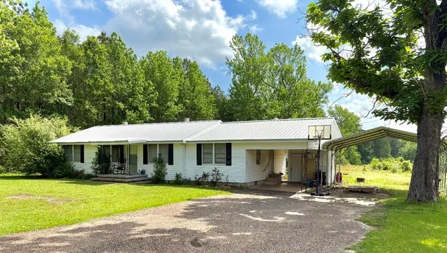 a front view of a house with swimming pool having outdoor seating